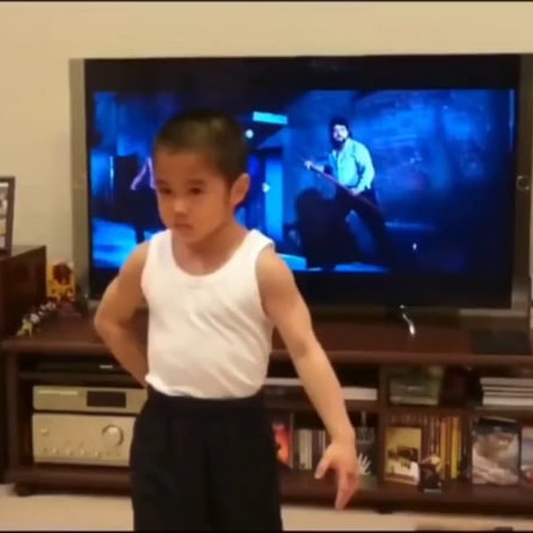 Child learned routine for this Bruce Lee nunchuck fight scene.