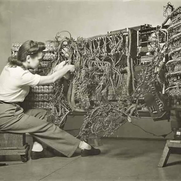 An engineer wiring an early ibm computer. 1958 photo by berenice abbott.