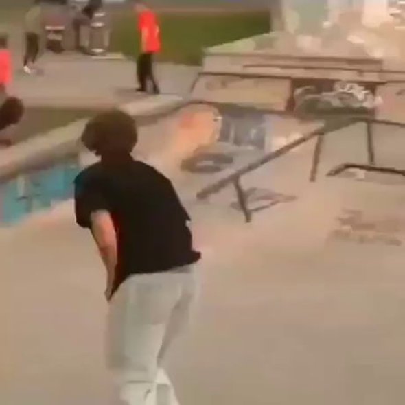 Skateboarder thinks quick and avoids collision with a younger skateboarder. He handles the event in an awesome way.