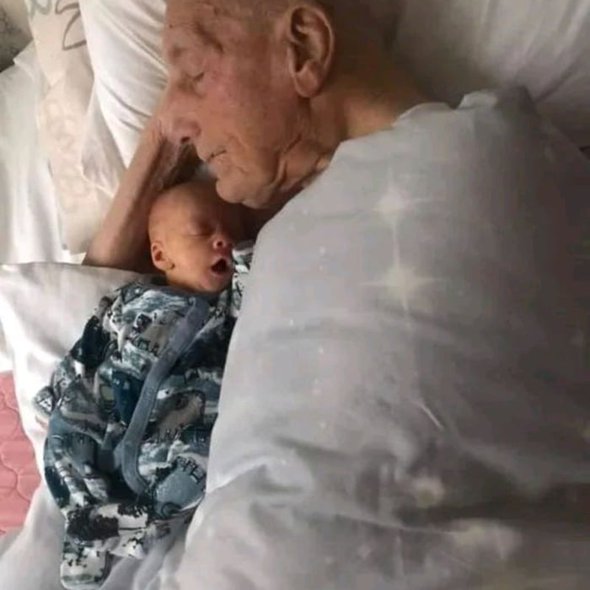 5-week-old Hunter snoozing alongside his 104-year-old great-great-grandfather Charles