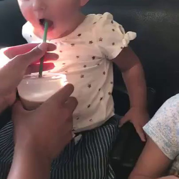 Baby tasting chocolate milk for the first time